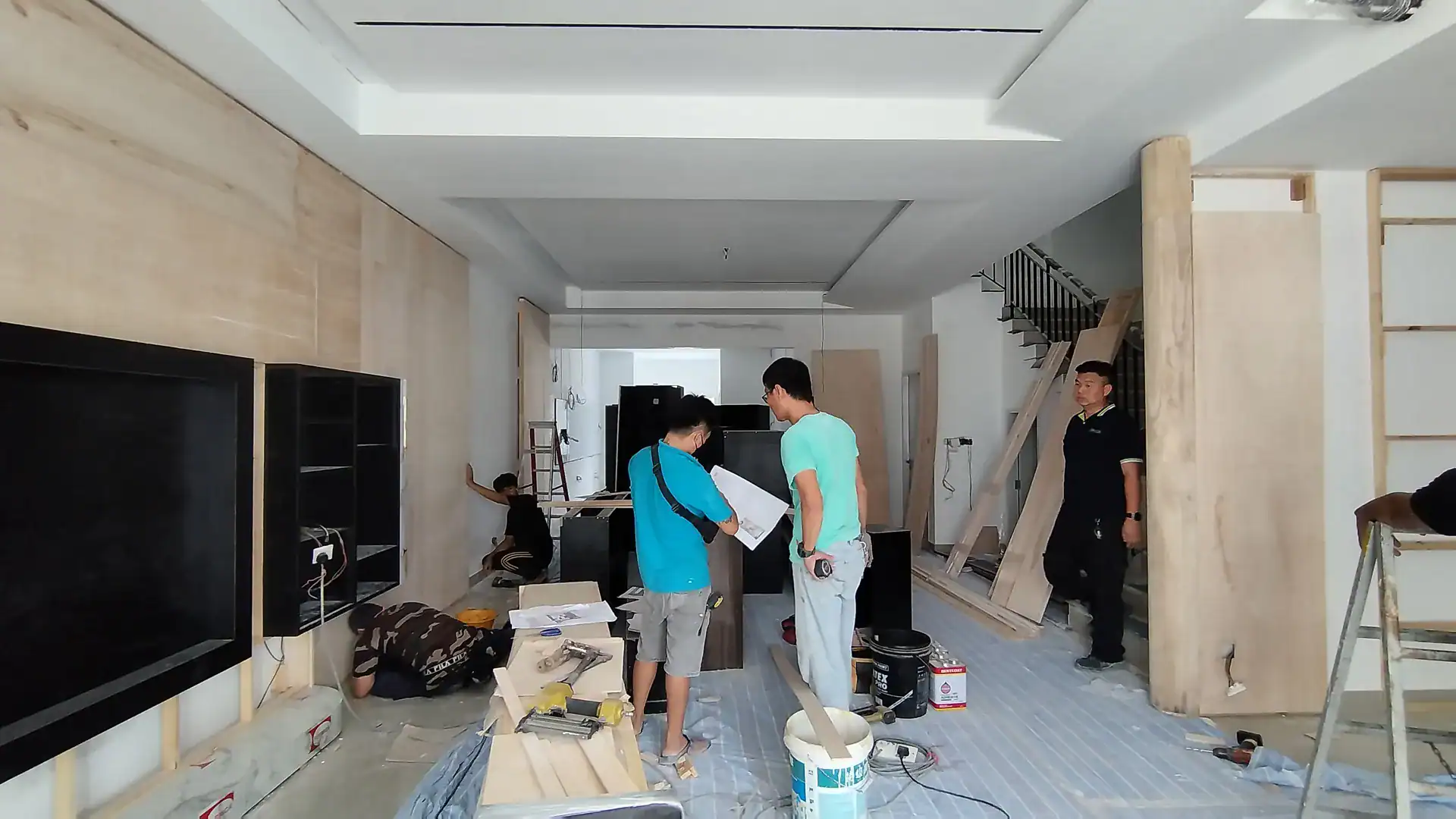 Modern interior renovation in progress, showcasing custom wooden wall paneling and contemporary design.