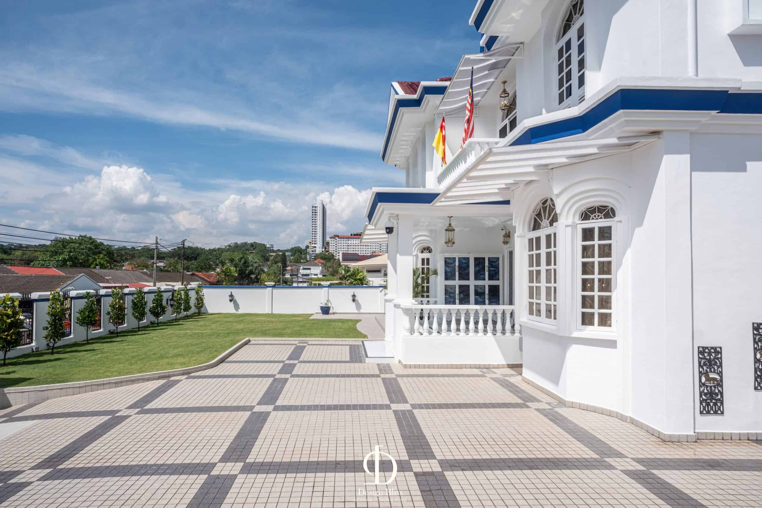 Véra Maison bungalow driveway with geometric paving and landscaped lawn in Malaysia