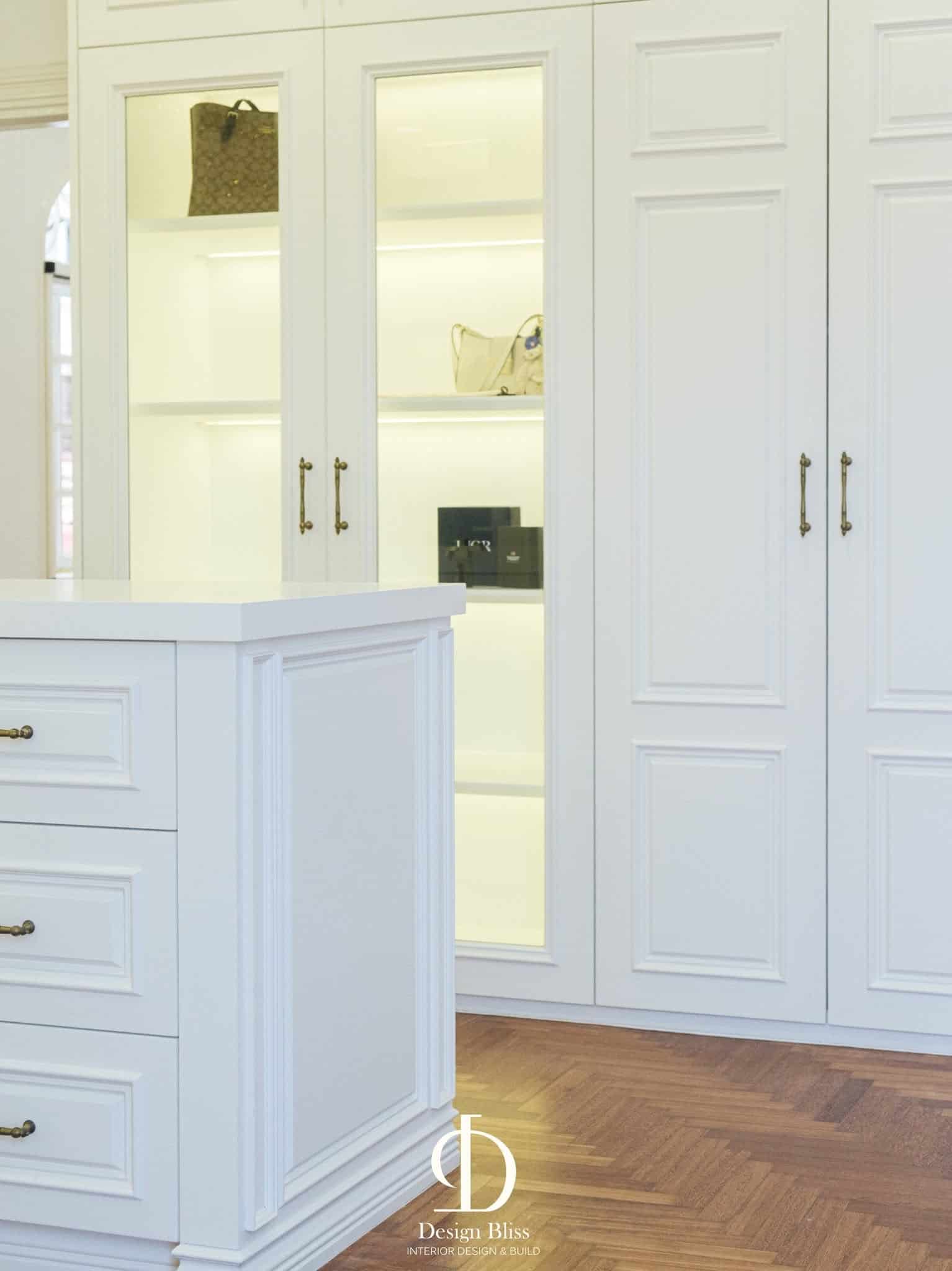 Illuminated wardrobe display cabinet with glass doors at Véra Maison